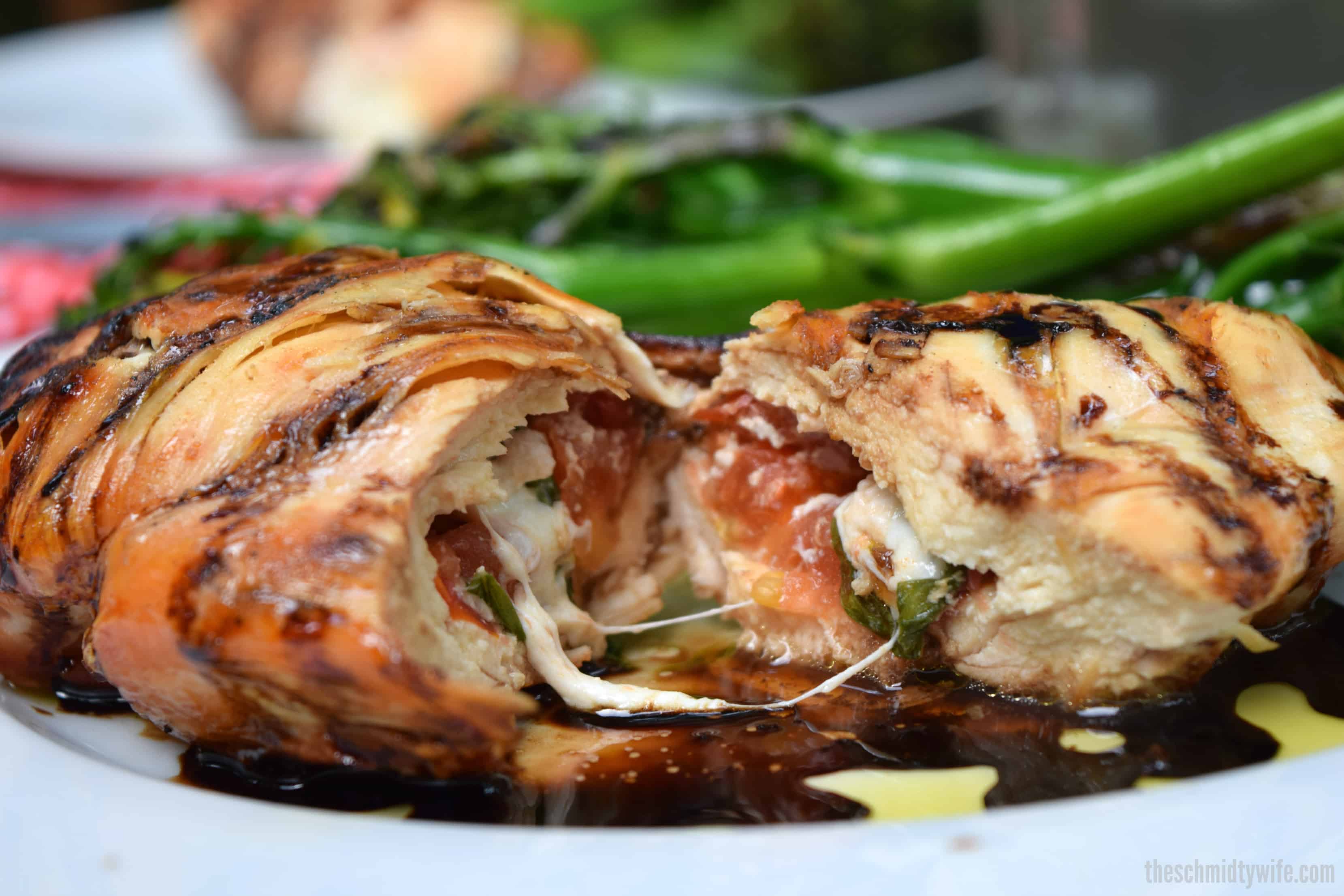 Grilled & Stuffed Caprese Chicken cut open revealing the caprese salad on the inside