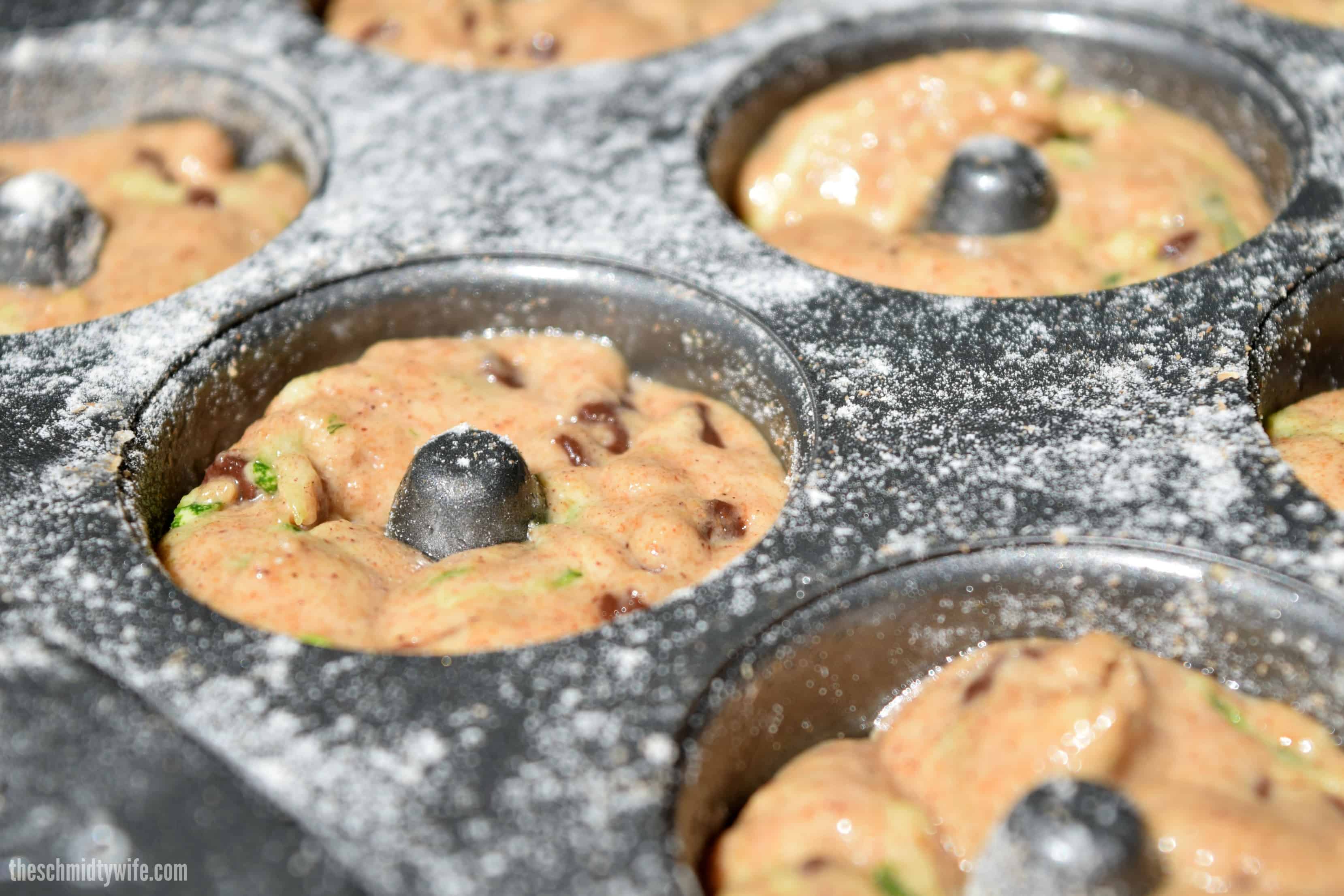 batter for Zucchini Donuts in donut tin before baking