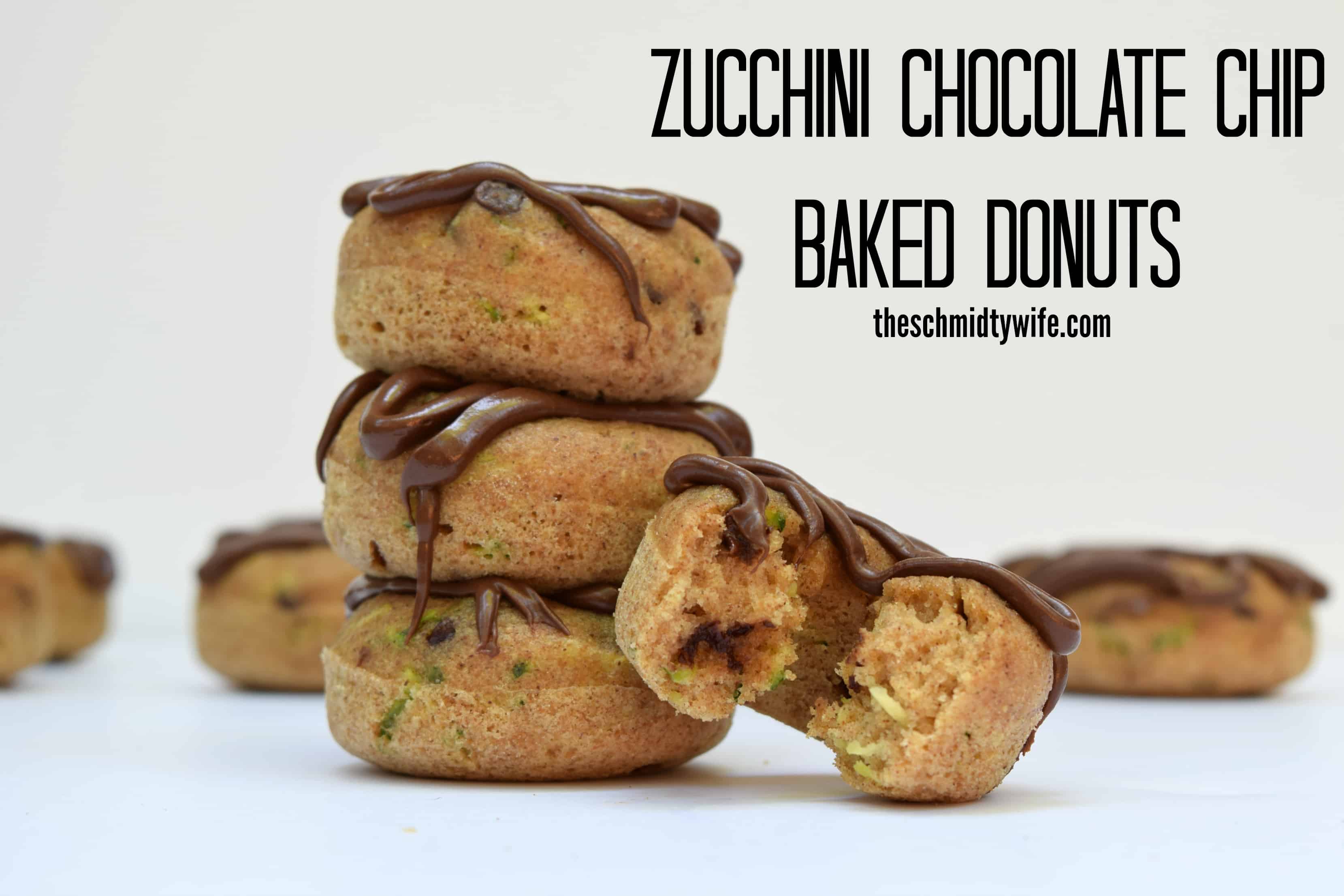 a stack of freshly made Zucchini Chocolate Chip Baked Donuts drizzled with melted chocolate