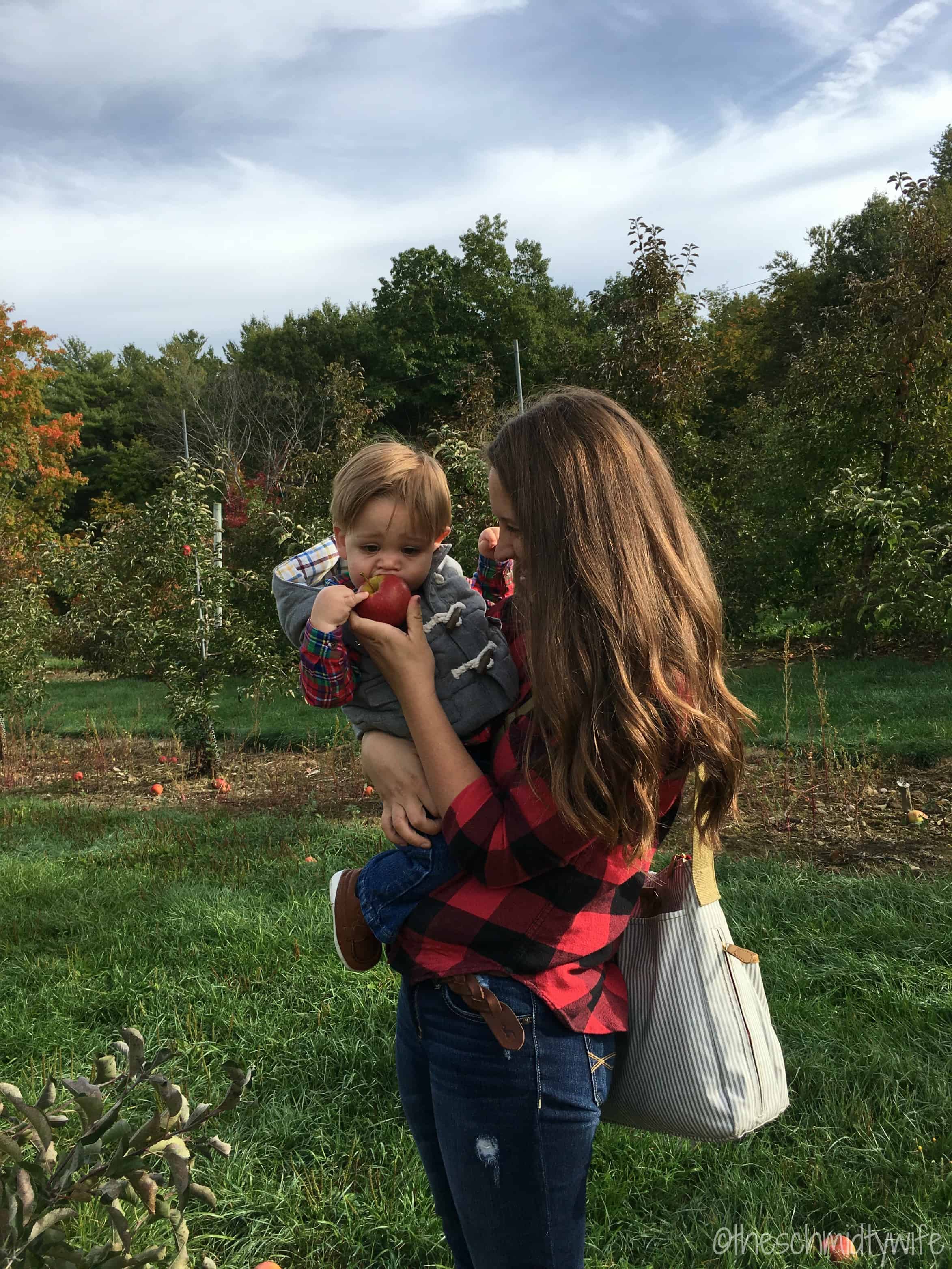 mother and son in apple orchard 
