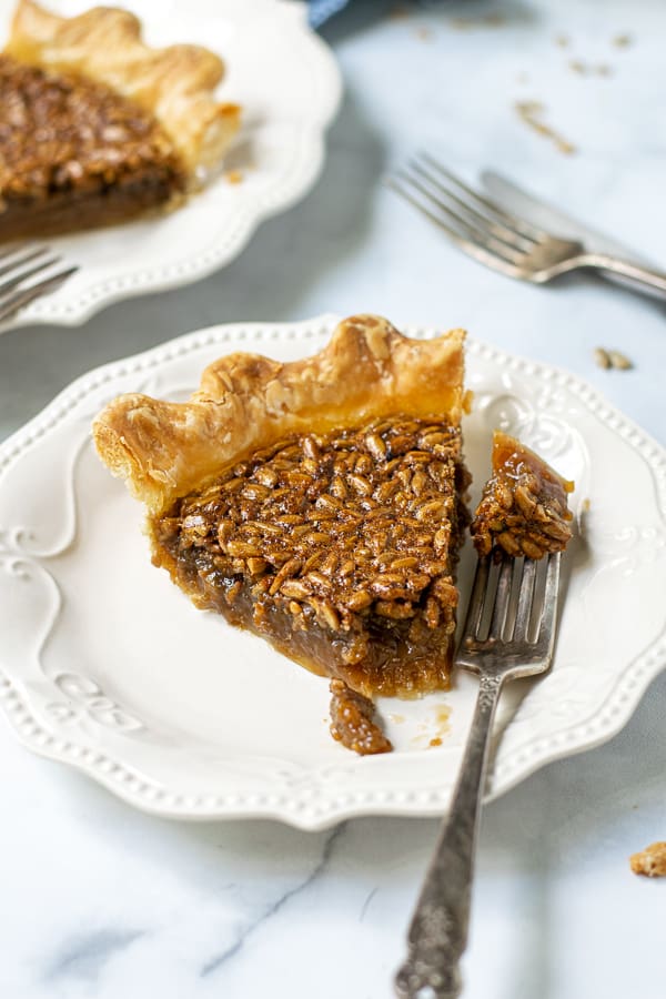bite of pie on a fork with a slice of pie