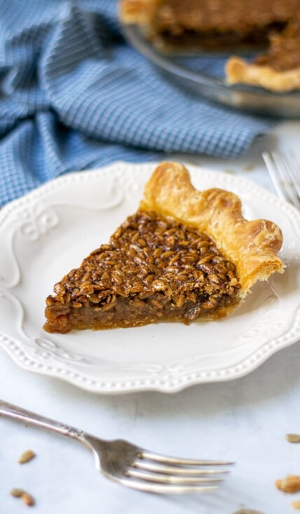 slice of sunflower seed pie on a plate showing off the gooey inside and crunchy top