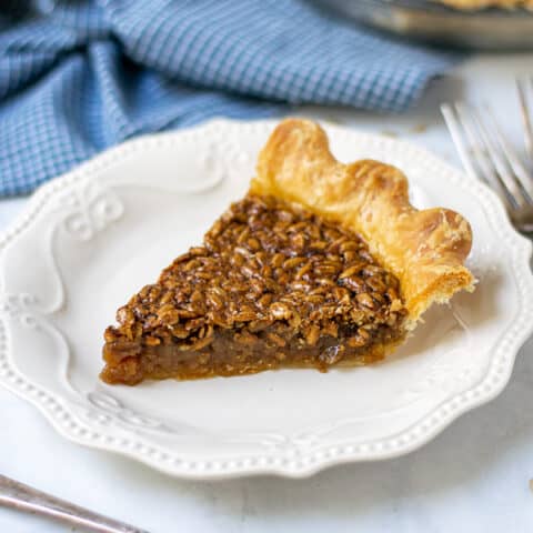 slice of sunflower seed pie on a plate showing off the gooey inside and crunchy top
