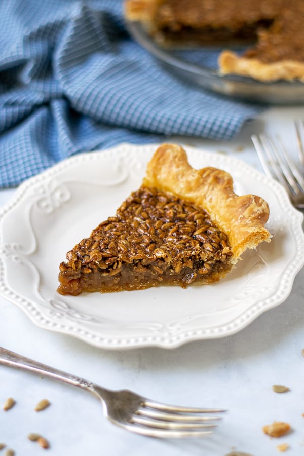 slice of sunflower seed pie on a plate showing off the gooey inside and crunchy top