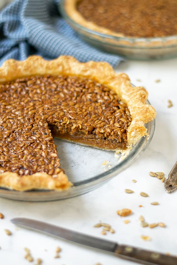 slice missing from a pie plate showing the inside of sunflower seed pie