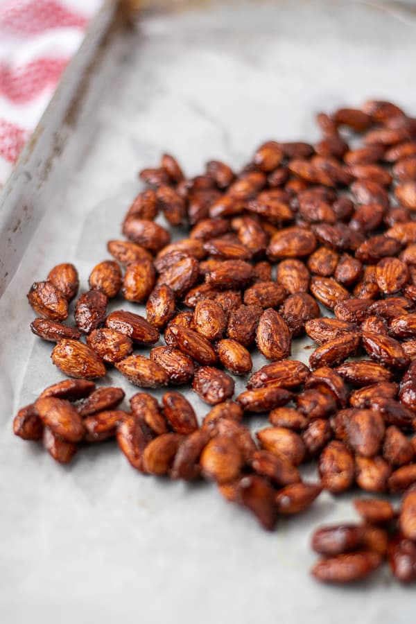 candied almonds spread out on a sheet pan