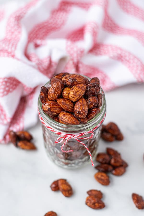 jar on a table filled with sweet and spicy candied almonds
