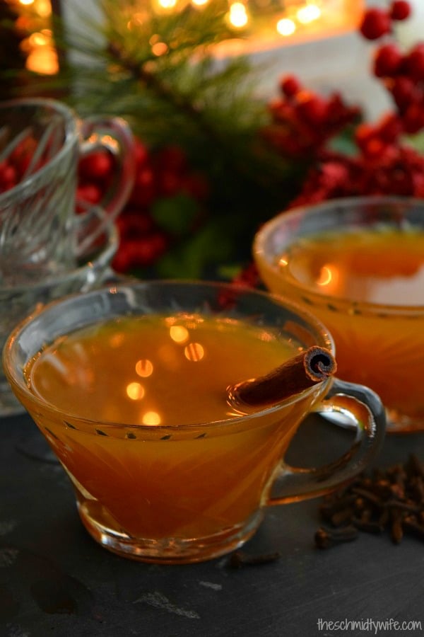 two cups of Crockpot Christmas Wassail with cinnamon sticks