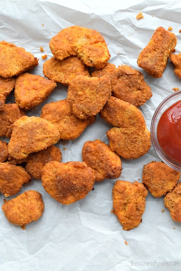 Baked Chicken Nuggets scattered on a piece of white paper