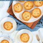 Pinterest Pin with text 'Leftover Mini Turkey Pot Pies', image with min pot pies on a white plate.