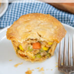 Pinterest Pin with text 'Leftover Mini Turkey Pot Pies', image with min pot pies on a white plate.