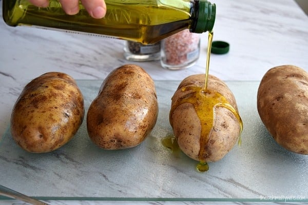 olive oil drizzles on a potato