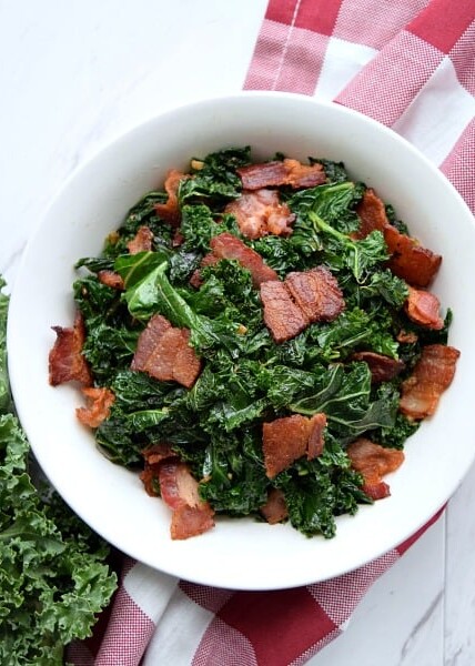 overhead shot of Sauteed Kale with Bacon in a white bowl