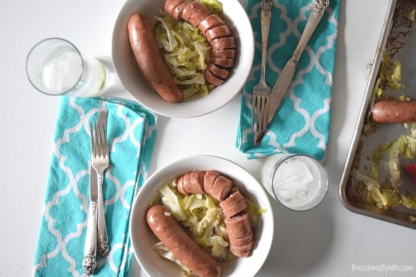 Roasted Cabbage with Chicken Sausage and onions and apples served in white bowls