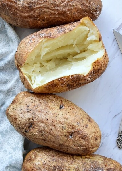 Baked Potato with a slice open showing the white insides