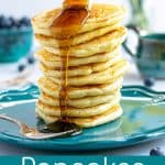 maple. syrup being drizzled on a stack of pancakes