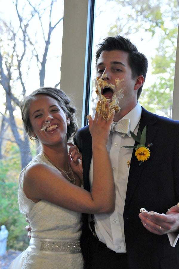 Bride and groom with cake on their face. 
