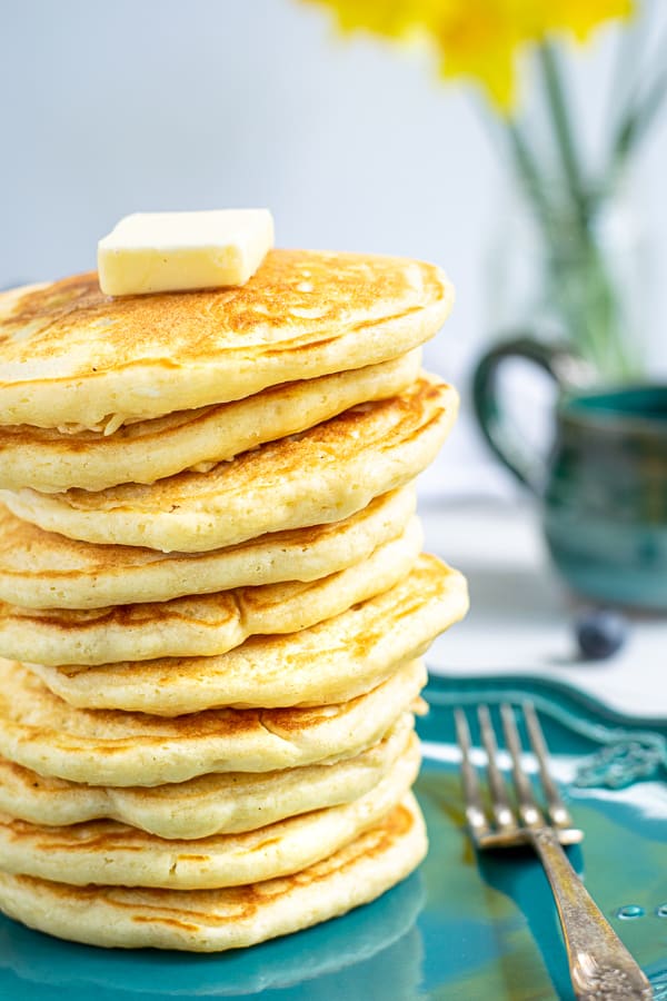 stack of homemade pancakes on a blue plate