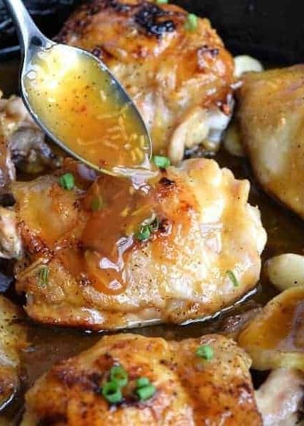 spoonful of Sticky Orange glaze on a Chicken Thigh