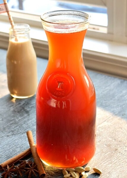 Homemade Chai Tea Concentrate sitting next to a window