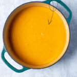 Pinterest Pin with text overlay, Roasted Butternut Squash Soup, image of of dutch oven filled with freshly made butternut squash soup.
