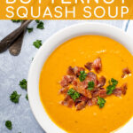 Pinterest Pin with text overlay, Roasted Butternut Squash Soup, image of a large bowl of butternut squash soup garnished with bacon and parsley.