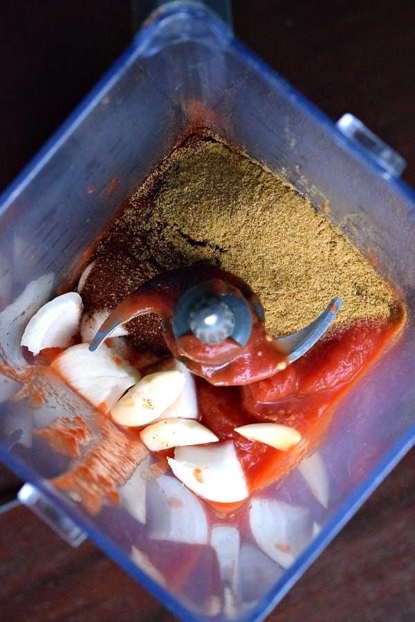 Ingredients for enchilada sauce sitting in blender