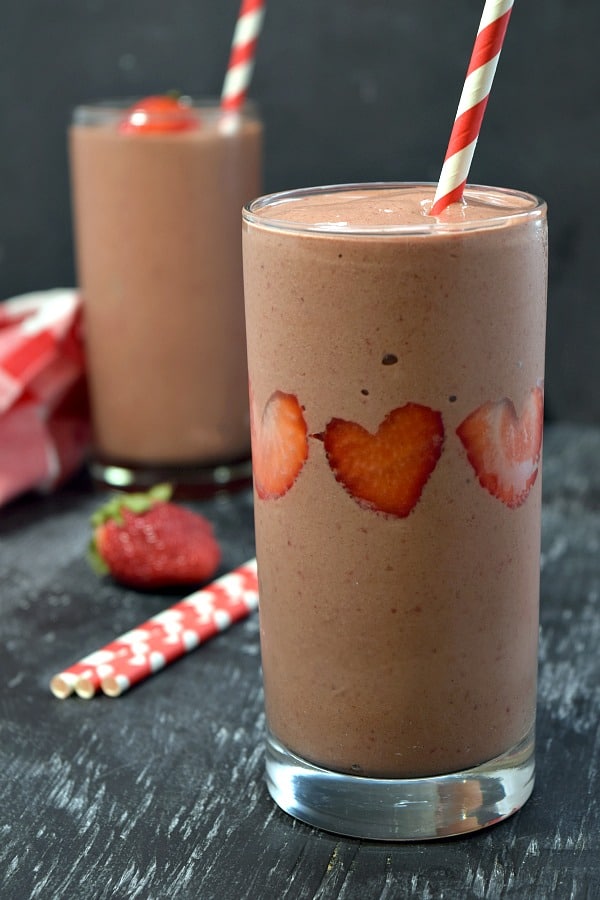 close up of strawberry chocolate smoothie with heart shaped strawberries