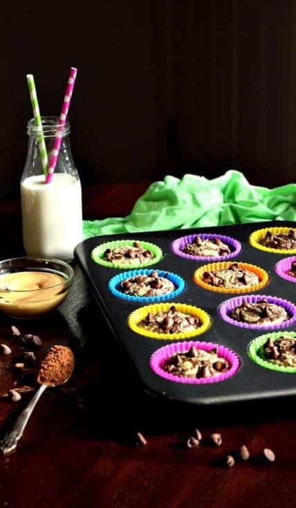 Chocolate Peanut Butter Muffins in a tin with milk on the table