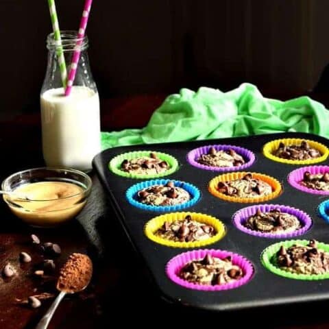 Chocolate Peanut Butter Muffins in a tin with milk on the table