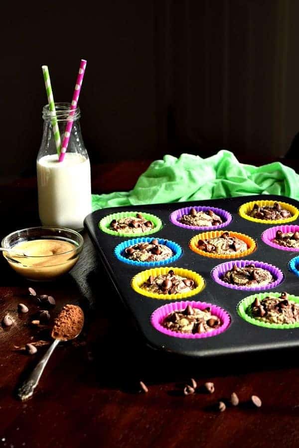 Chocolate Peanut Butter Muffins in a tin with milk on the table