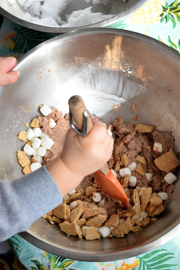 toddler mixing s'more snow ice cream