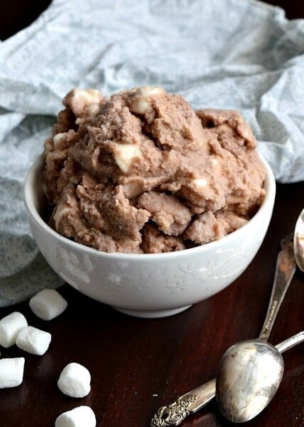 a small bowl of s'mores snow ice cream with marshmallows and spoons