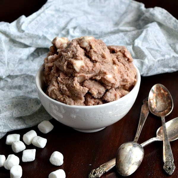 a small bowl of s'mores snow ice cream with marshmallows and spoons