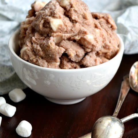 a small bowl of s'mores snow ice cream with marshmallows and spoons