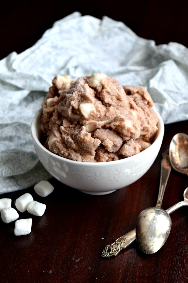 a small bowl of s'mores snow ice cream with marshmallows and spoons