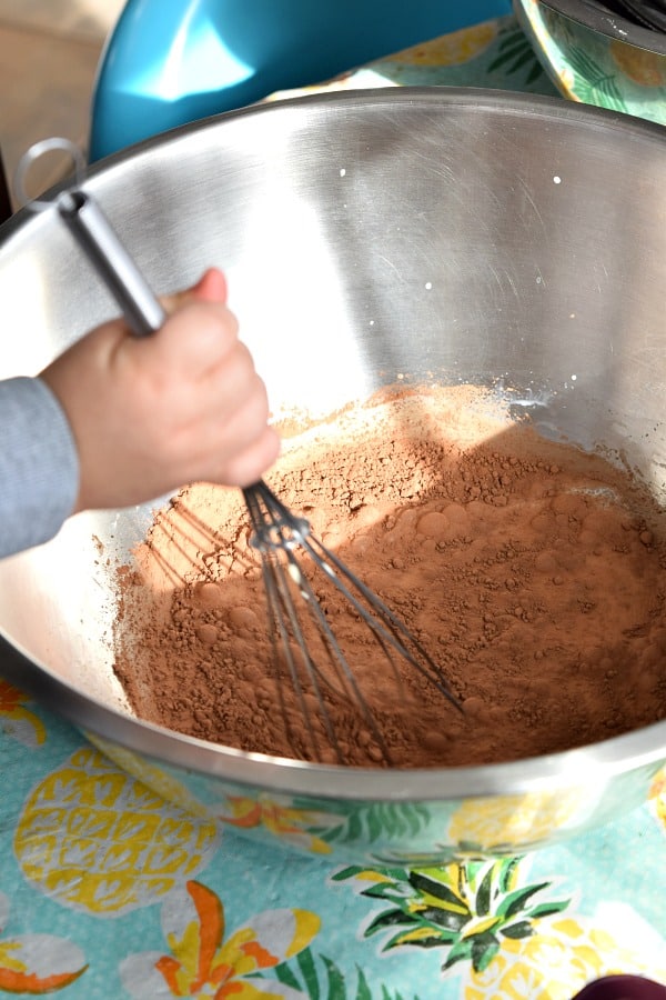 toddler hands mixing milk for snow ice cream