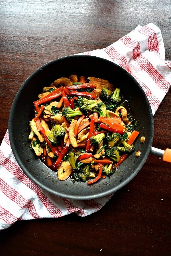 overhead shot of a skillet full of chicken stir fry with colorful vegetables