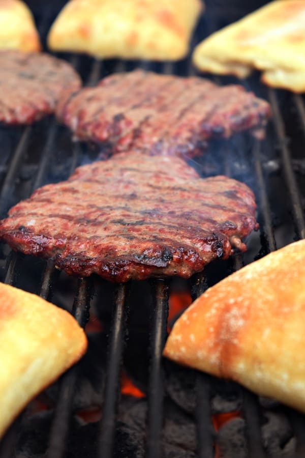 Burgers grilling on a charcoal grill