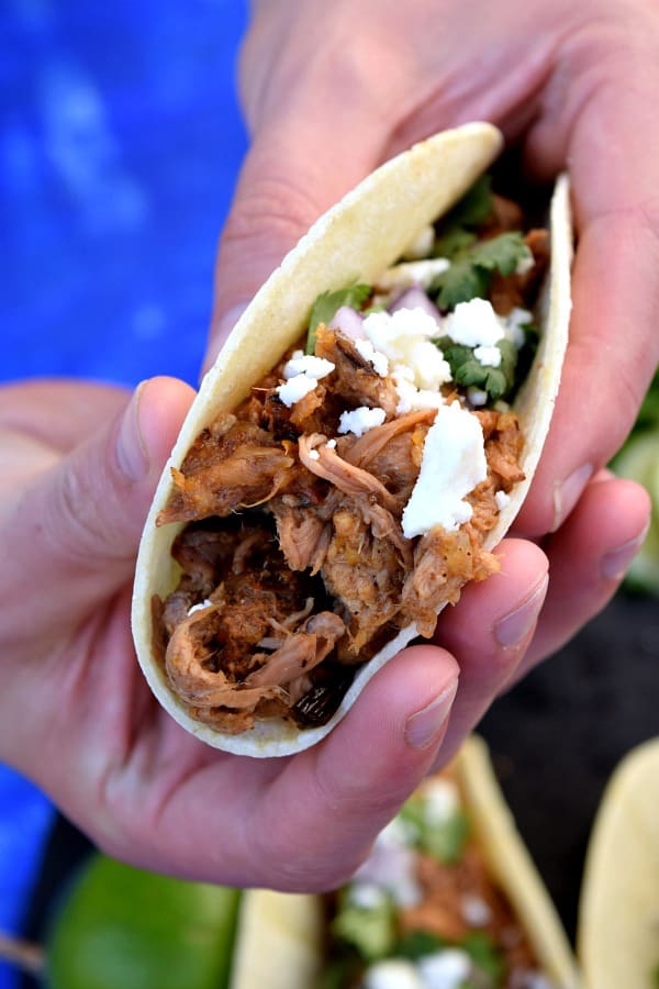 Slow Cooker Chipotle Pineapple Carnitas ready to be eaten by a pair of hungry hands