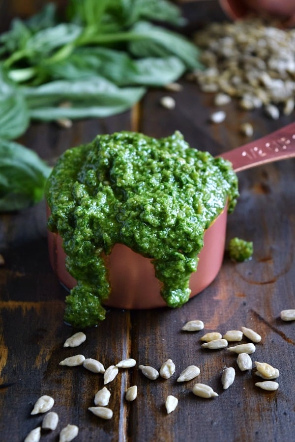 freshly made sunflower seed basil pesto in a measuring cup