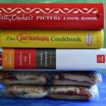 Italian Pressed Picnic Sandwich being pressed down by large cookbooks