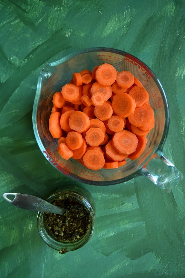 the ingredients, sliced up carrots ready for the grill and a jar of pesto ready for tossing 