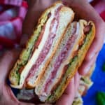 hands holding two halves of a pressed sandwich showing the insides