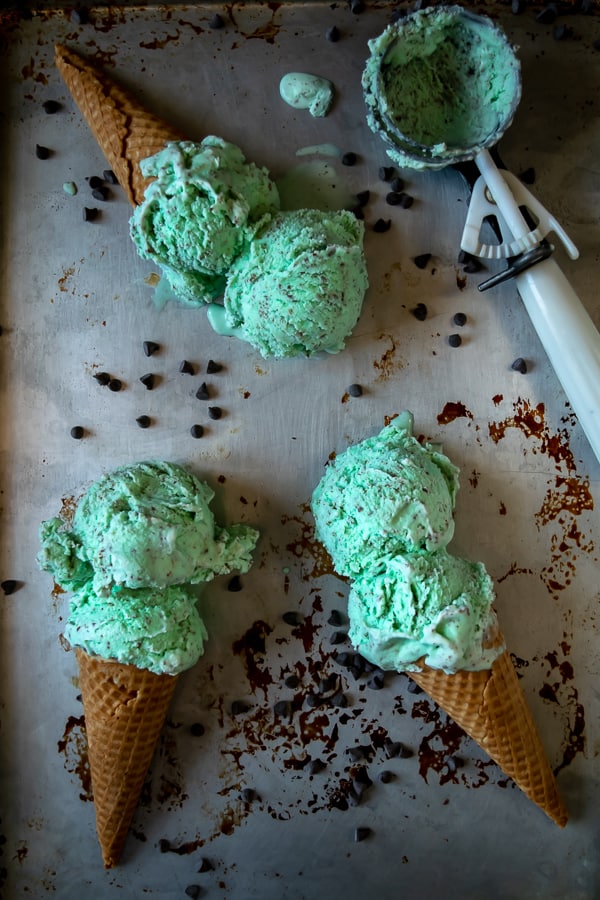 Homemade Mint Chocolate Chip Ice Cream - 3 cones laying on a sheet