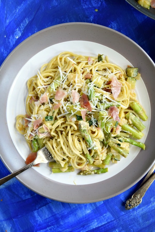 a plate full of Summer Spaghetti Carbonara, with a fork twisting the pasta