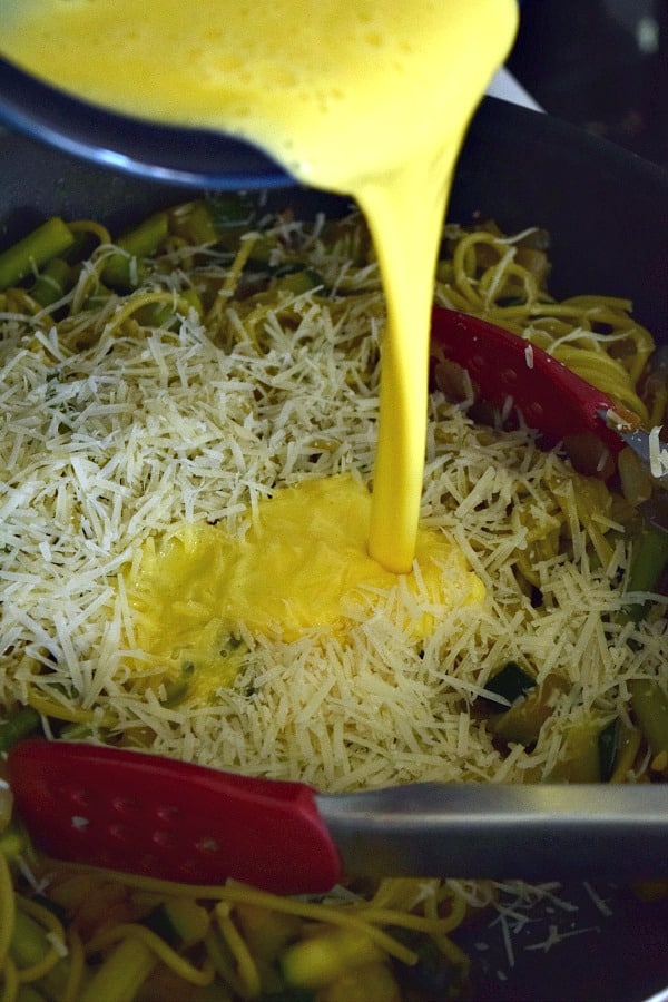 Adding the yolks to the skillet to make Summer Spaghetti Carbonara