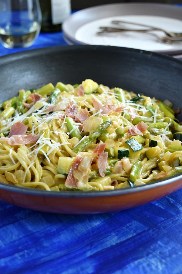 Summer Spaghetti Carbonara in a skillet topped with cheese