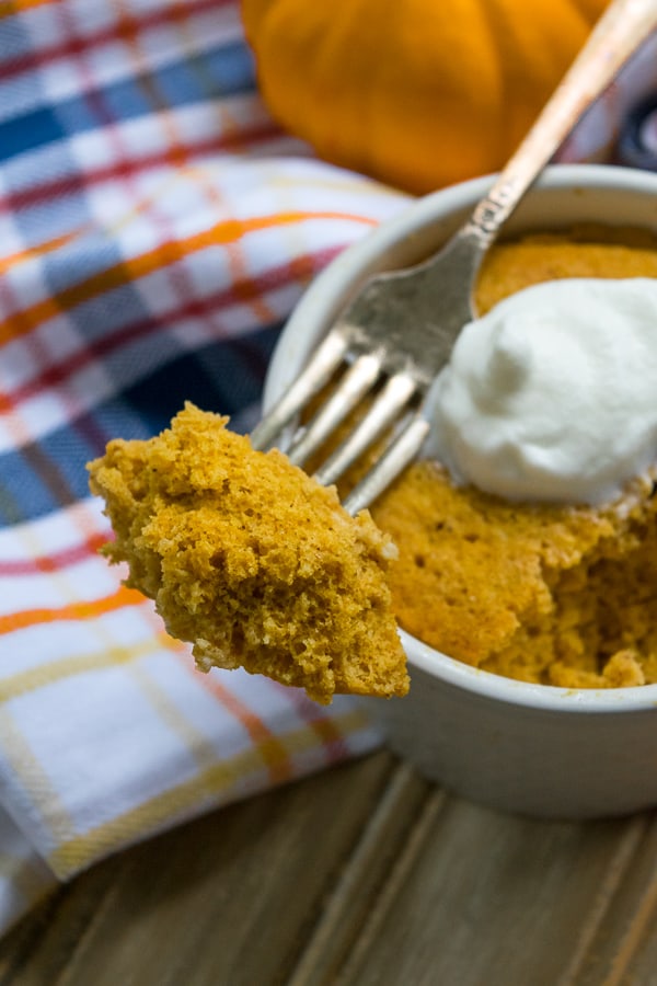 a bite on a fork of healthy pumpkin mug muffin (single serve)