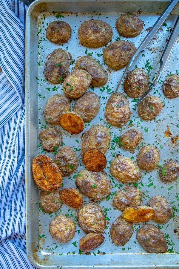 overhad sheet pan full of Crispy Oven Roasted Baby Yukon Potatoes